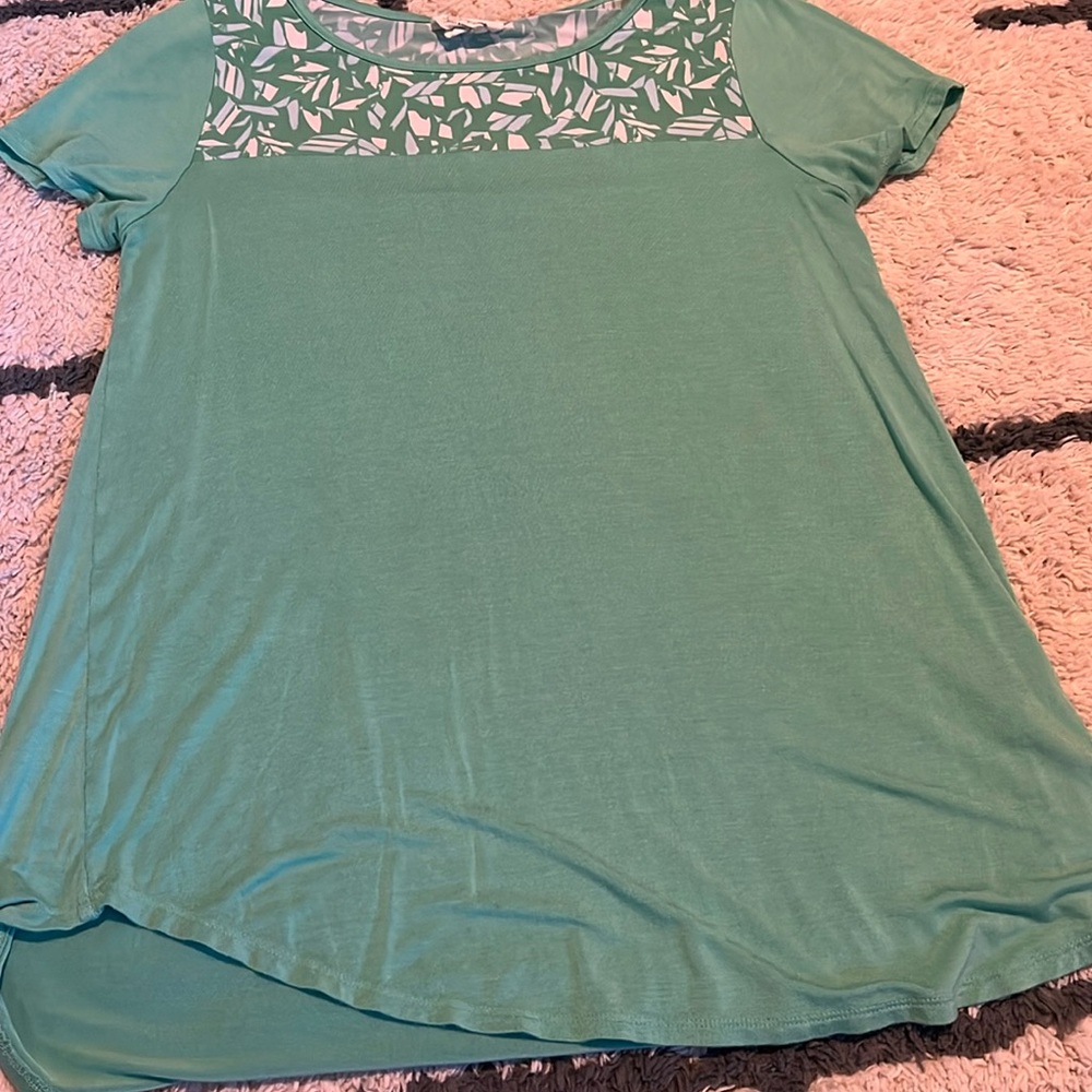 Check out this beautiful light weight shirt! Feather detail at the top!